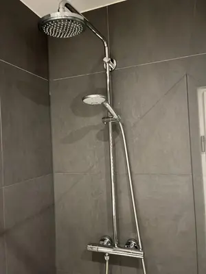 a shower with a shower head in a bathroom at Modern Hideout Ace Location in Amsterdam