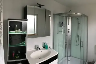 a bathroom with a sink and a glass shower at Ferienhaus Good Times mit eigenem Steg Ferienpark Vislust Ijsselmeer in Wervershoof