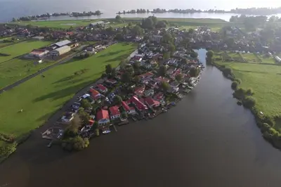 an aerial view of a river with a group of houses at Ferienhaus Good Times mit eigenem Steg Ferienpark Vislust Ijsselmeer in Wervershoof