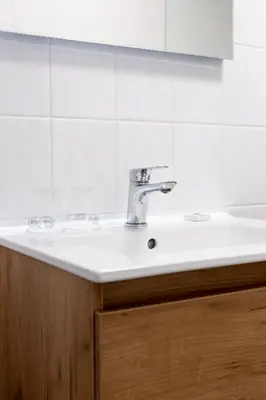 a sink in a bathroom with a mirror at Studio Parkweg in Bergen aan Zee