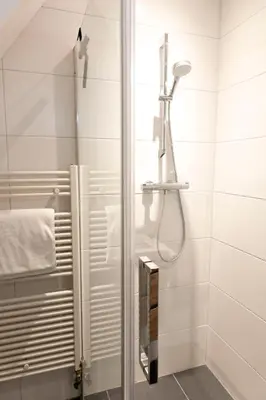 a bathroom with a shower with a glass door at Appartement Parkweg in Bergen aan Zee