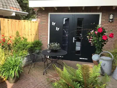 a black front door with a table and some plants at Studio/appartment EVI in Zandvoort