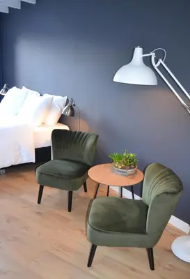 a bedroom with two chairs and a table and a bed at Studio/appartment EVI in Zandvoort