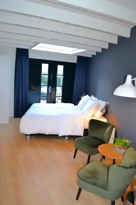 a bedroom with a bed and a table and a chair at Studio/appartment EVI in Zandvoort