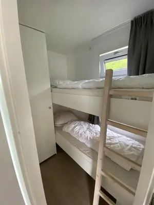 a room with two bunk beds and a window at Luxe Chalet Marbella IJmuiden aan Zee in IJmuiden