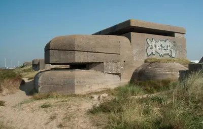 a concrete monument with graffiti on it on a hill at Luxe Chalet Marbella IJmuiden aan Zee in IJmuiden