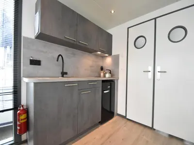 a kitchen with stainless steel cabinets and a sink at Boat in Volendam near Marina Museum in Volendam