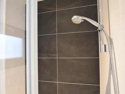 a shower with a shower head in a bathroom at Boat in Volendam near Marina Museum in Volendam
