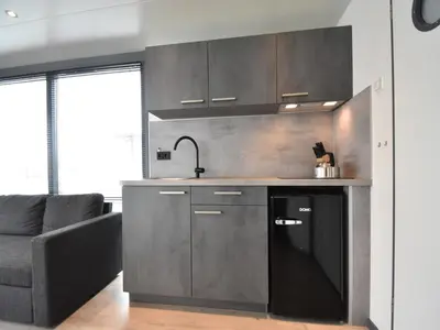 a kitchen with a sink and a couch in a room at Boat in Volendam near Marina Museum in Volendam
