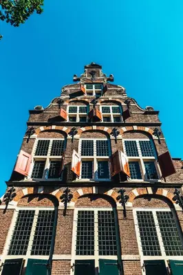 a tall building with windows on top of it at Relais & Châteaux Weeshuis Gouda in Gouda