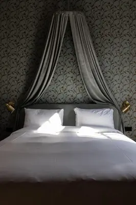 a bedroom with a large bed with a canopy at Relais & Châteaux Weeshuis Gouda in Gouda