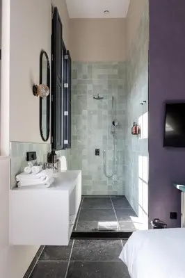 a bathroom with a shower and a sink and a tub at Relais & Châteaux Weeshuis Gouda in Gouda