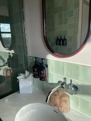 a bathroom sink with a mirror and a sink at Relais & Châteaux Weeshuis Gouda in Gouda