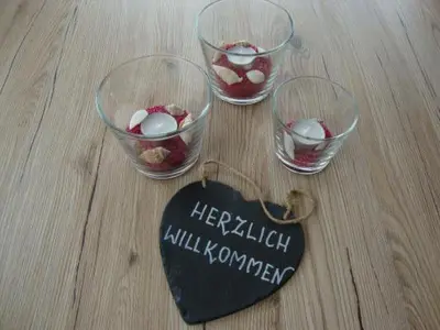 three glass bowls with food in them on a table at Ferienpark Vislust Modernes Holzhaus am Ijsselmeer mit eigenen Steg in Wervershoof
