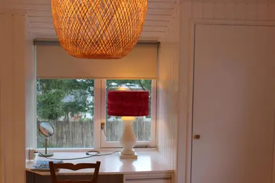 a lamp sitting on a desk next to a window at Klein Oldenburg in Bergen