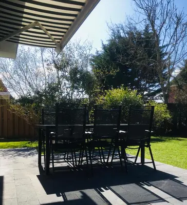 a table and chairs sitting on a patio at Bendalong Noordwijk in Noordwijk