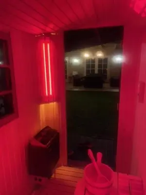 a room with a red light in a house at Bungalow between Amsterdam and Haarlem with sauna in Vijfhuizen