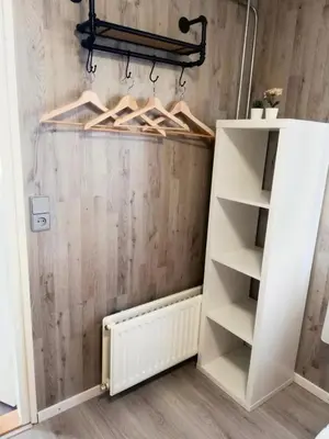 a room with white shelves and a wall at Cozy chalet in Opmeer near Amsterdam and Beach in Opmeer
