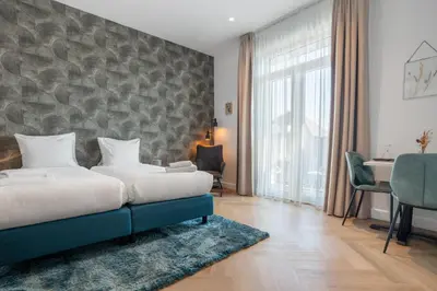 a hotel room with a bed and a desk at Boutique Hotel At Sea in Zandvoort