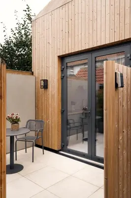 a patio with sliding glass doors and a table at Beachhouse SeaBreeze - vernieuwd! in Noordwijk