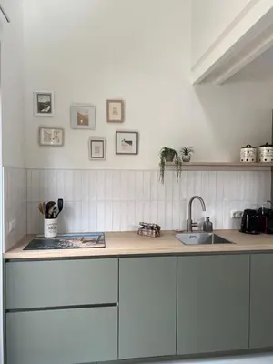a kitchen with white cabinets and a sink at Beachhouse SeaBreeze - vernieuwd! in Noordwijk