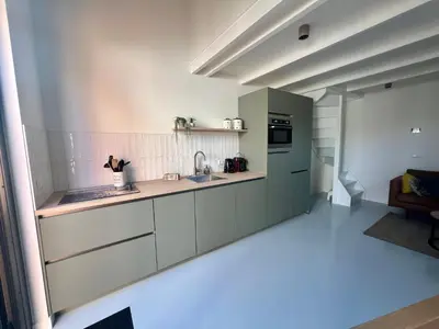 a kitchen with a sink and a counter top at Beachhouse SeaBreeze - vernieuwd! in Noordwijk