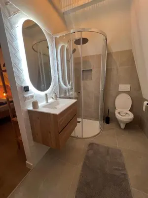 a bathroom with a sink and a shower and a toilet at Beachhouse SeaBreeze - vernieuwd! in Noordwijk
