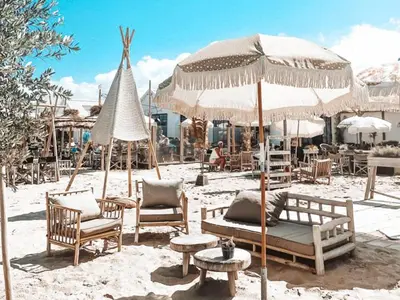 a group of chairs and umbrellas on a beach at Beachhouse SeaBreeze - vernieuwd! in Noordwijk
