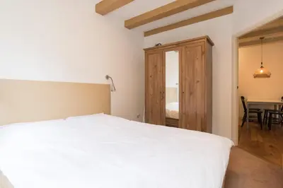 a bedroom with a white bed and a table at Kloveniers Studio in Amsterdam