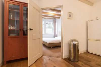 an open door leading to a bedroom with a bed at Kloveniers Studio in Amsterdam