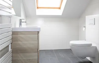 a white bathroom with a sink and a toilet at Thalatta in Noordwijk