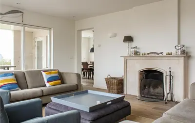 a living room with a couch and a fireplace at Thalatta in Noordwijk