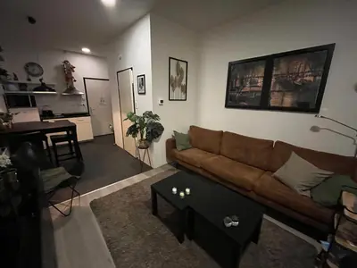 a living room with a couch and a table at Studio E in Purmerend