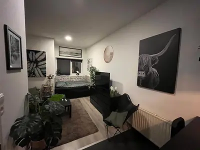 a living room with a couch and a table at Studio E in Purmerend