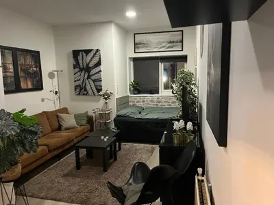 a living room with a couch and a table at Studio E in Purmerend