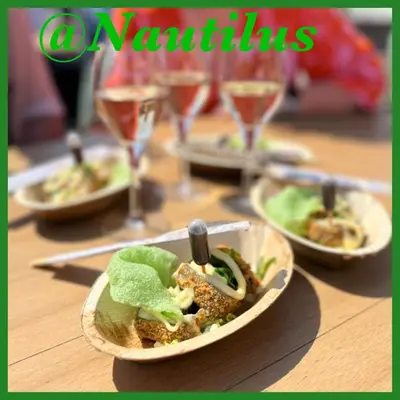 a table with plates of food and glasses of wine at HuisjehurenEgmond in Egmond aan Zee
