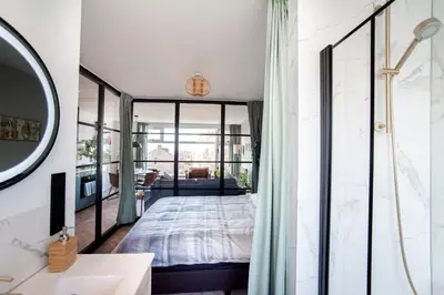 a bedroom with a bed and a mirror at Shell 61 in Zandvoort