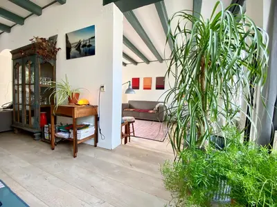 a living room with a table and a couch at The New Fisherman’s House in Zandvoort