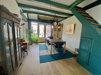 a dining room with a wooden table and chairs at The New Fisherman’s House in Zandvoort