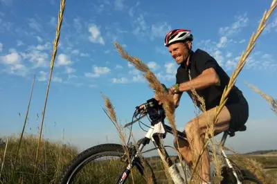 a man riding a bike through a field at The New Fisherman’s House in Zandvoort