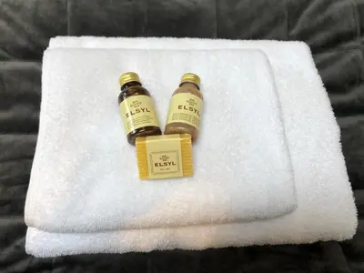 two bottles of honey sitting on a white towel at Zandvoortferienwohnungen in Zandvoort