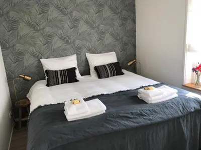 a bedroom with a bed with towels on it at Zandvoortferienwohnungen in Zandvoort