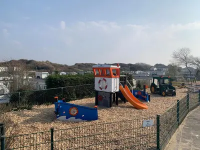 a playground with a slide and a play structure at Chalet Playa direct aan zee in IJmuiden in IJmuiden