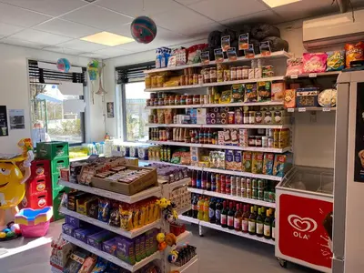 a store aisle with a lot of food and drinks at Chalet Playa direct aan zee in IJmuiden in IJmuiden