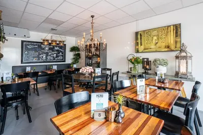 a dining room with wooden tables and chairs at Chalet Playa direct aan zee in IJmuiden in IJmuiden