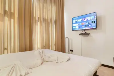 a bedroom with a bed and a flat screen tv at Haarlem Apart Hotel in Haarlem