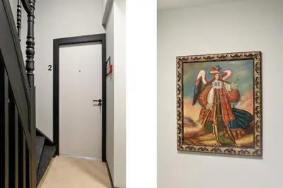 a painting hanging on a wall next to a hallway at Haarlem Apart Hotel in Haarlem