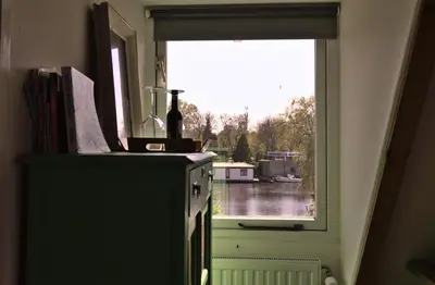 a window with a bottle of wine on top of a stove at At the Butchers in Amsterdam