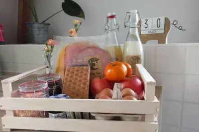a crate filled with fruits and vegetables and bottles at At the Butchers in Amsterdam