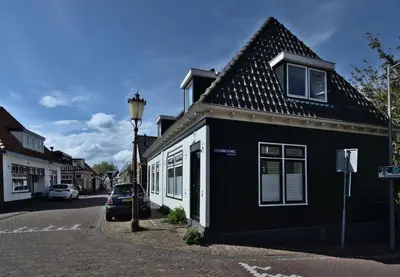 a black and white building on the side of a street at At the Butchers in Amsterdam